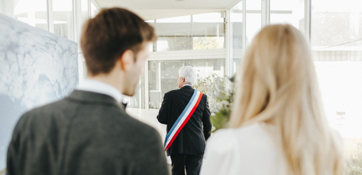 A civil ceremony taking place in a French town hall on a wedding day