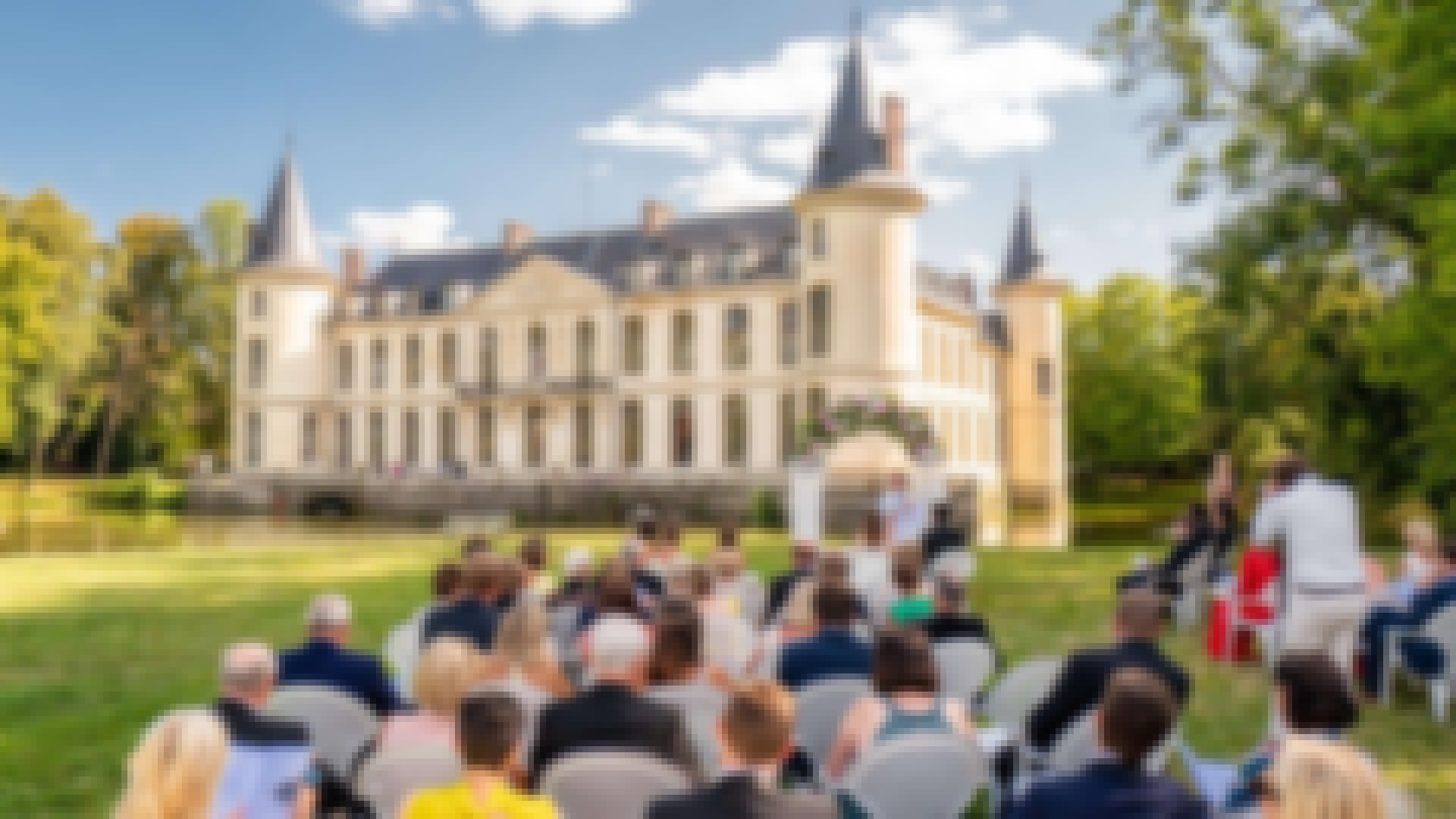 couple photographié lors d'un mariage avec en fond un château réservé pour leur mariage