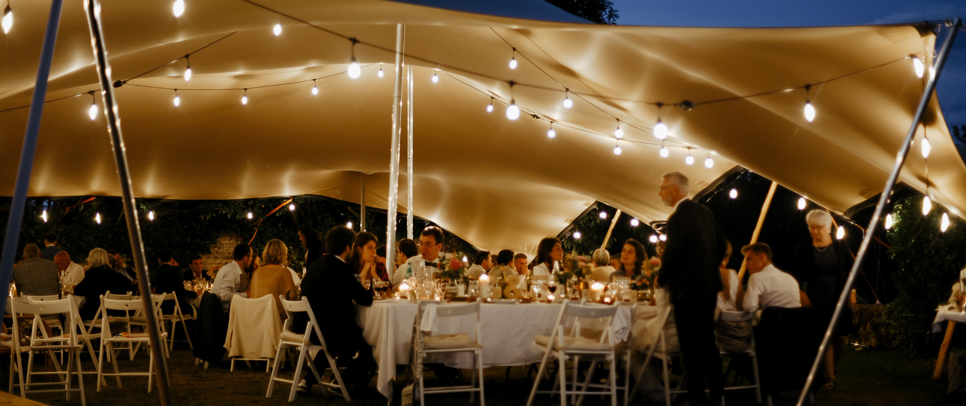 Alfresco wedding dinner under the marquee of Château de Bois Rigaud in the south of France