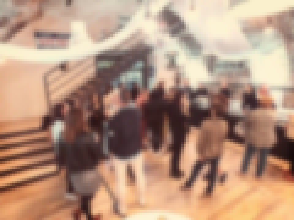 People standing at a cocktail organised in one of the reception rooms at château de Bois Rigaud in France